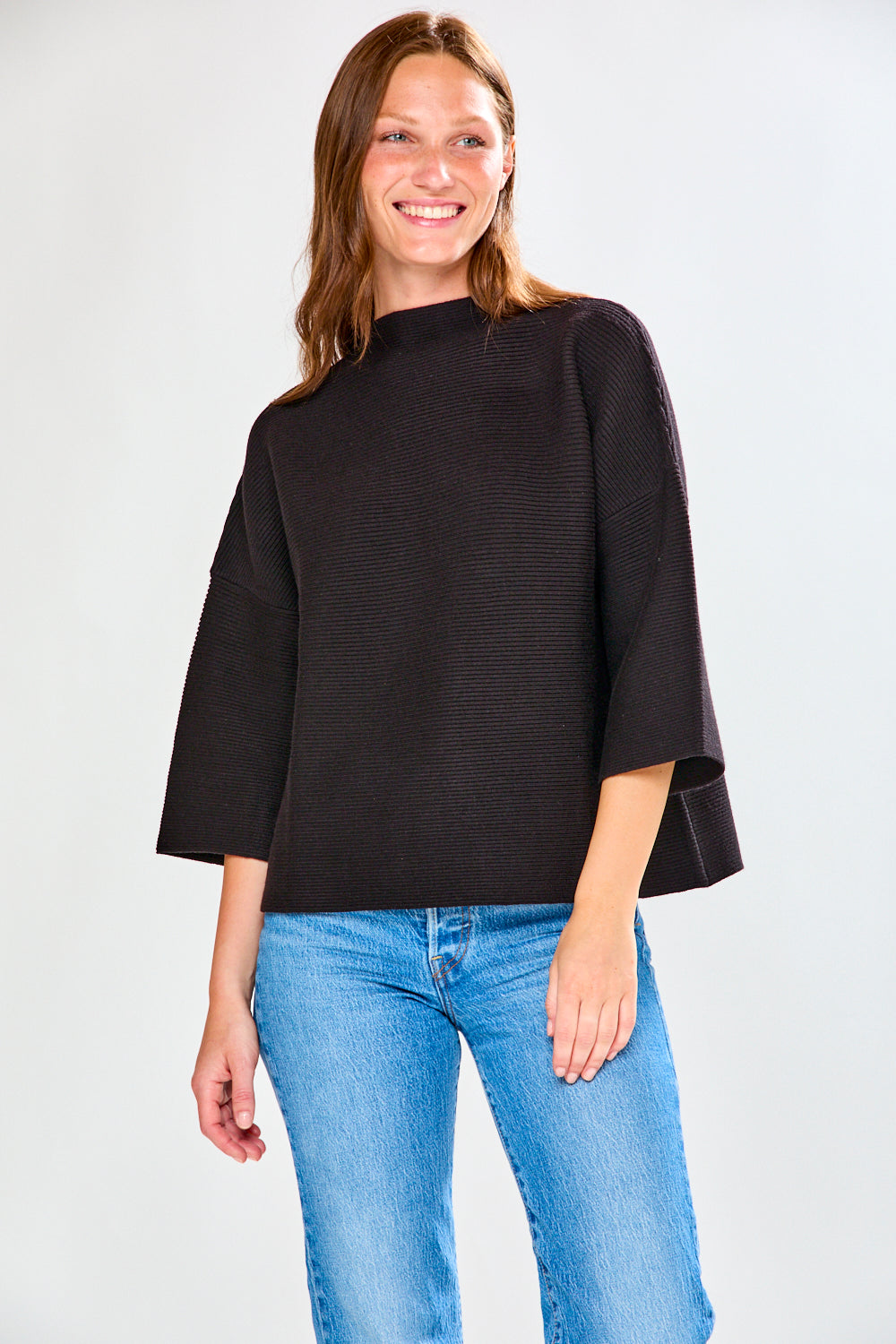 Woman in black ribbed sweater