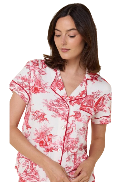 Woman wearing a pink and white toile pajama set on a white background