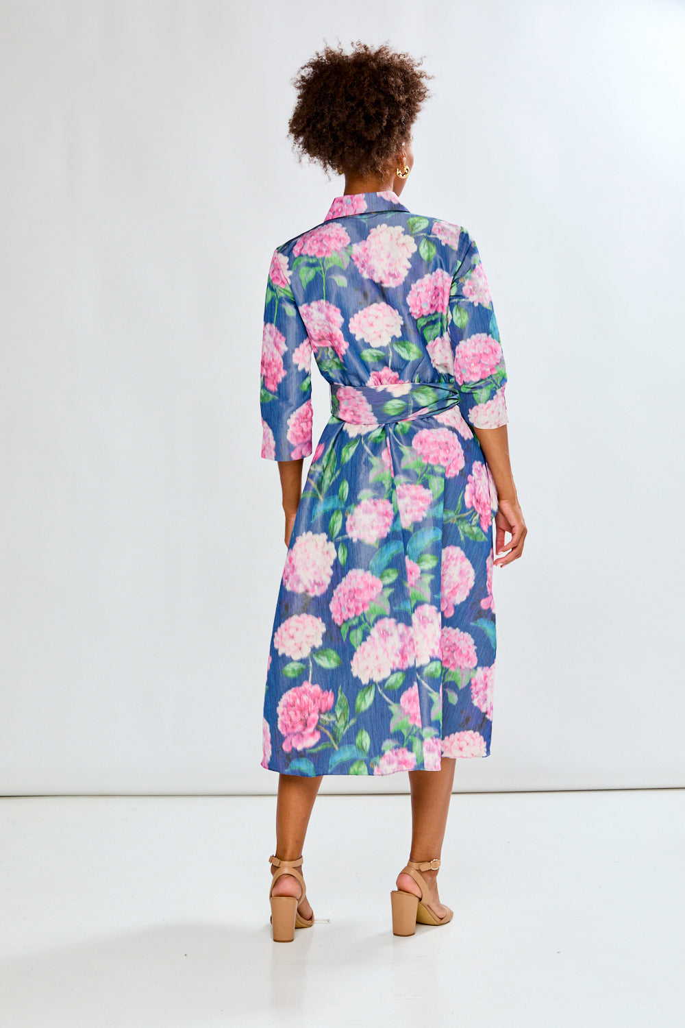 Woman in tea length floral dress