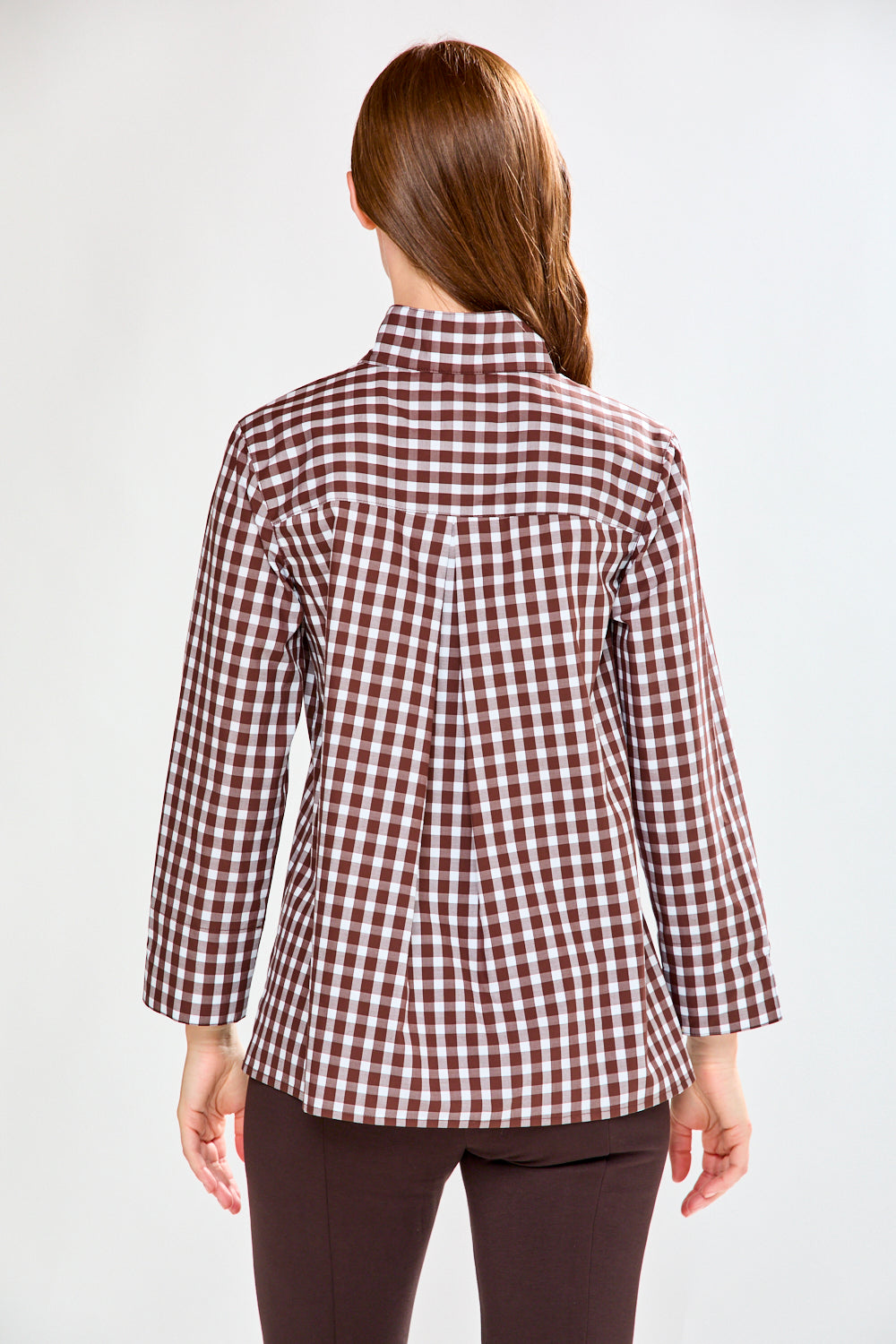 Woman in chocolate/white check top