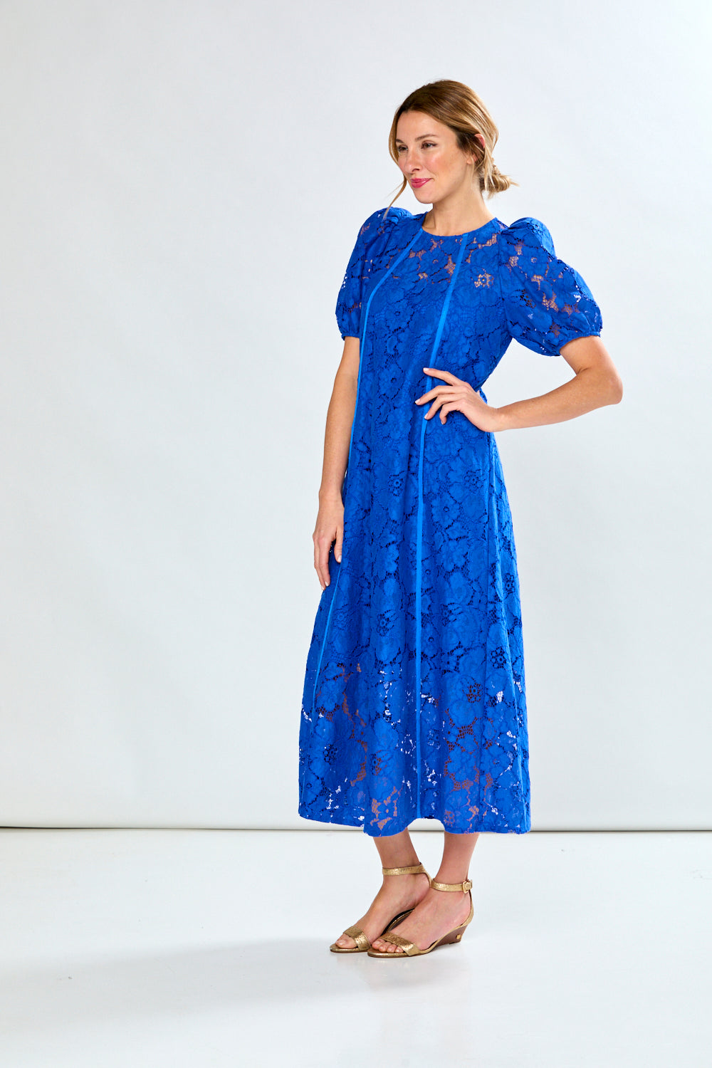 Woman in royal eyelet dress