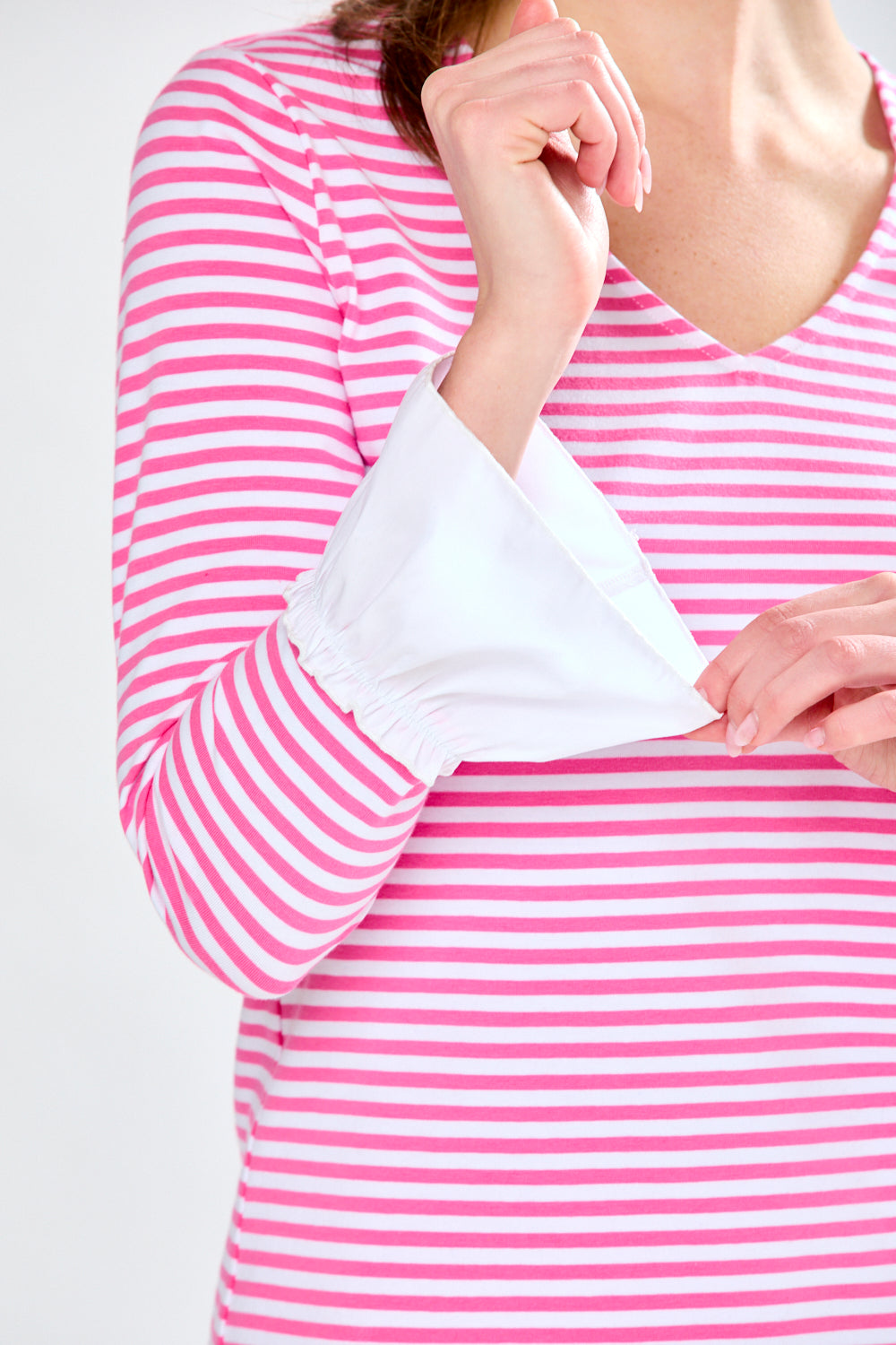 Woman in pink and white stripe top