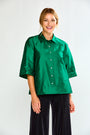 Woman wearing a green shirt with a collar on a white background