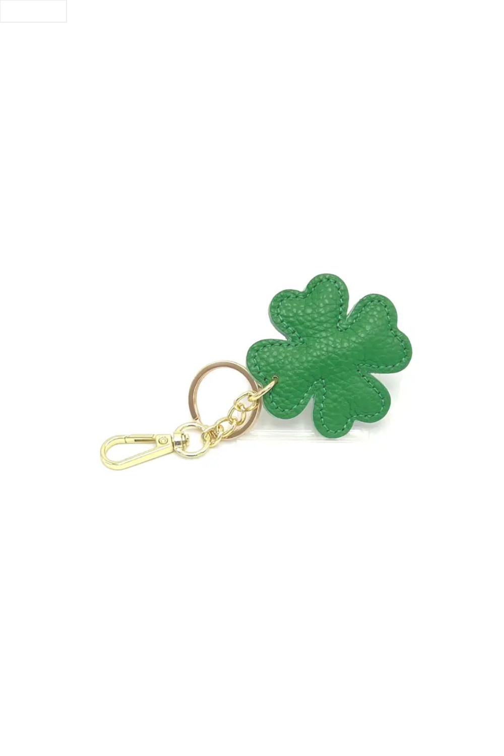 Green four-leaf clover keychain on a white background