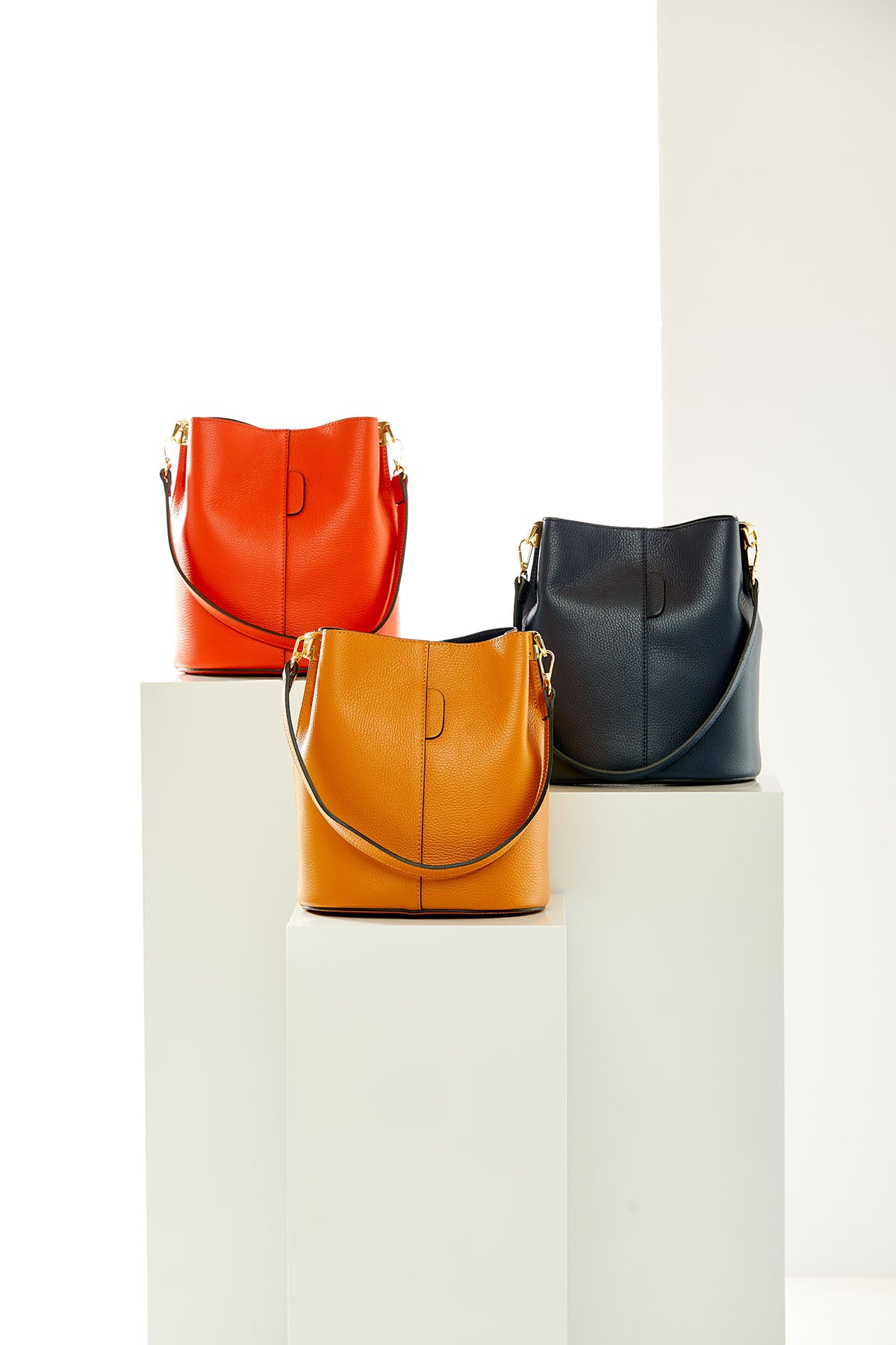 Orange, camel, and black bucket bag