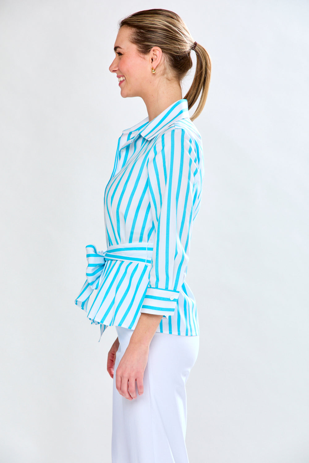 Woman in aqua and white stripe top