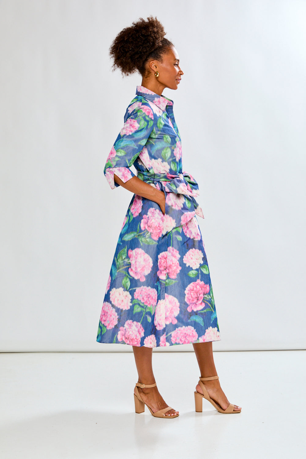 Woman in tea length floral dress