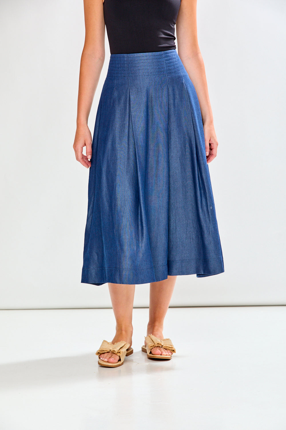 Person wearing a blue skirt on a white background