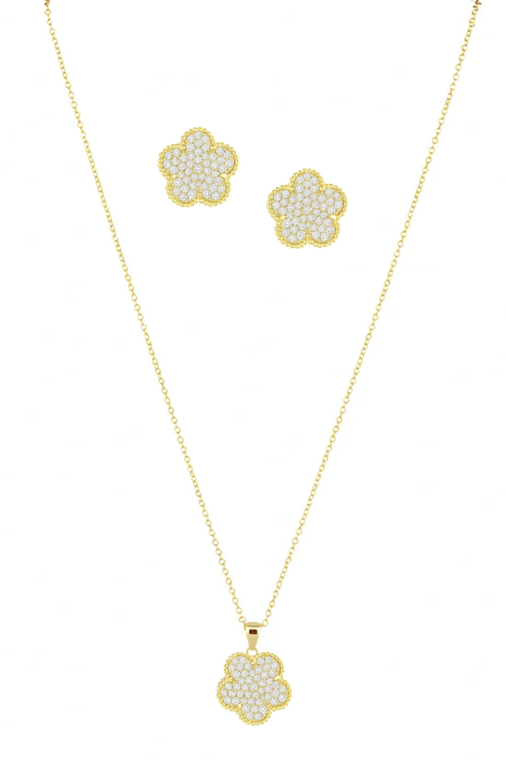 Gold necklace and earrings with pearl accents on a white background