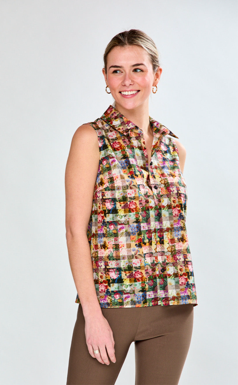 Woman wearing a colorful patterned sleeveless top against a plain background