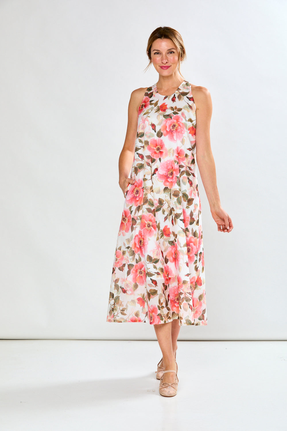 Woman in coral poppies dress