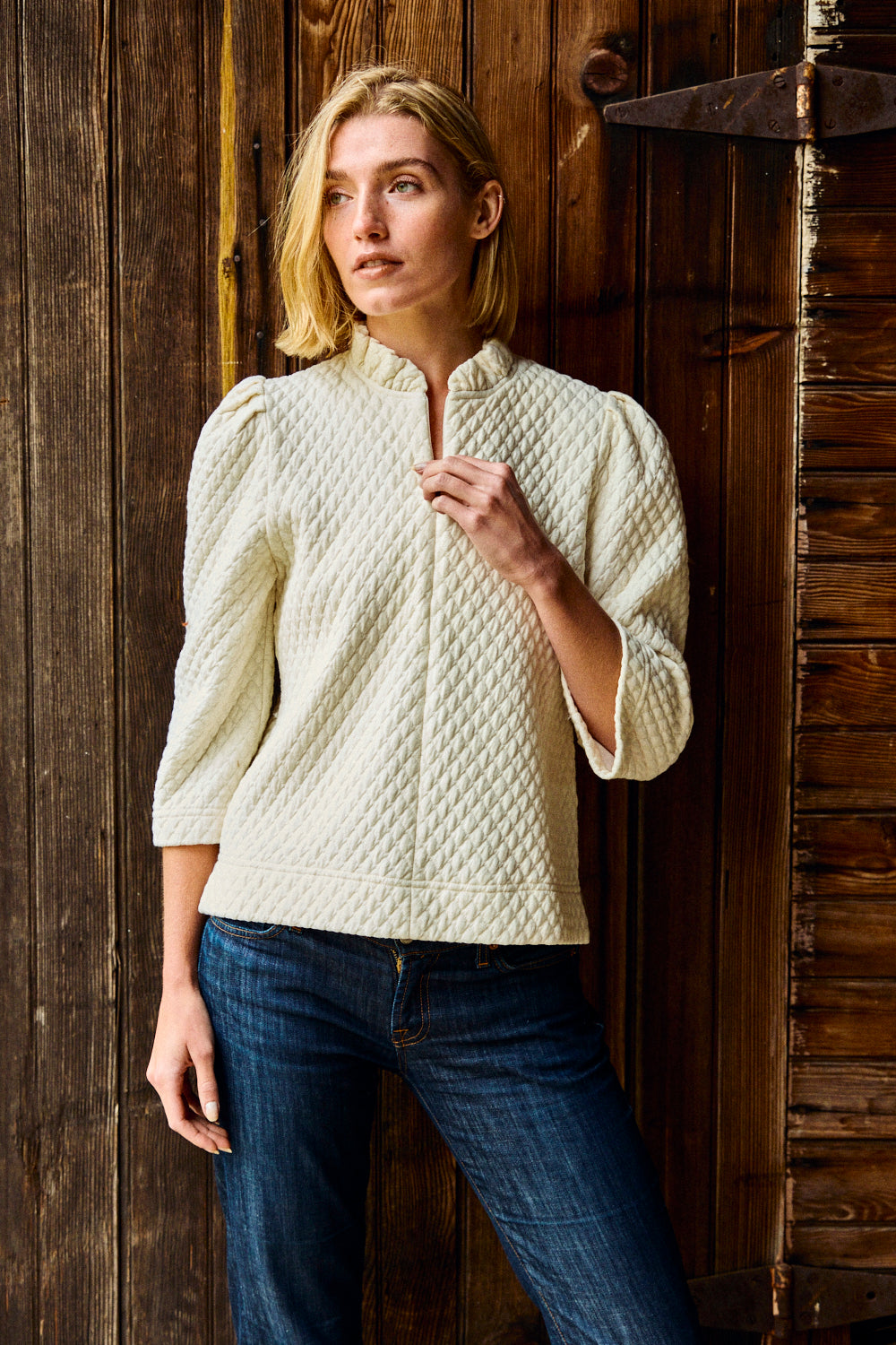 Woman wearing a textured white shirt and blue jeans
