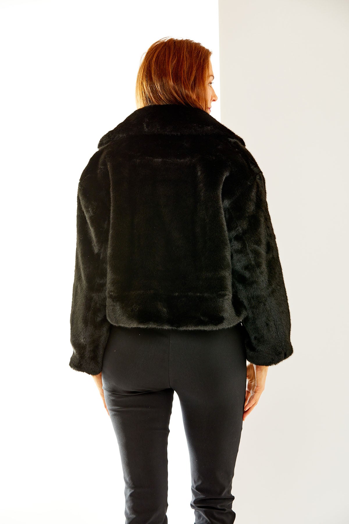 Woman in black faux fur jacket