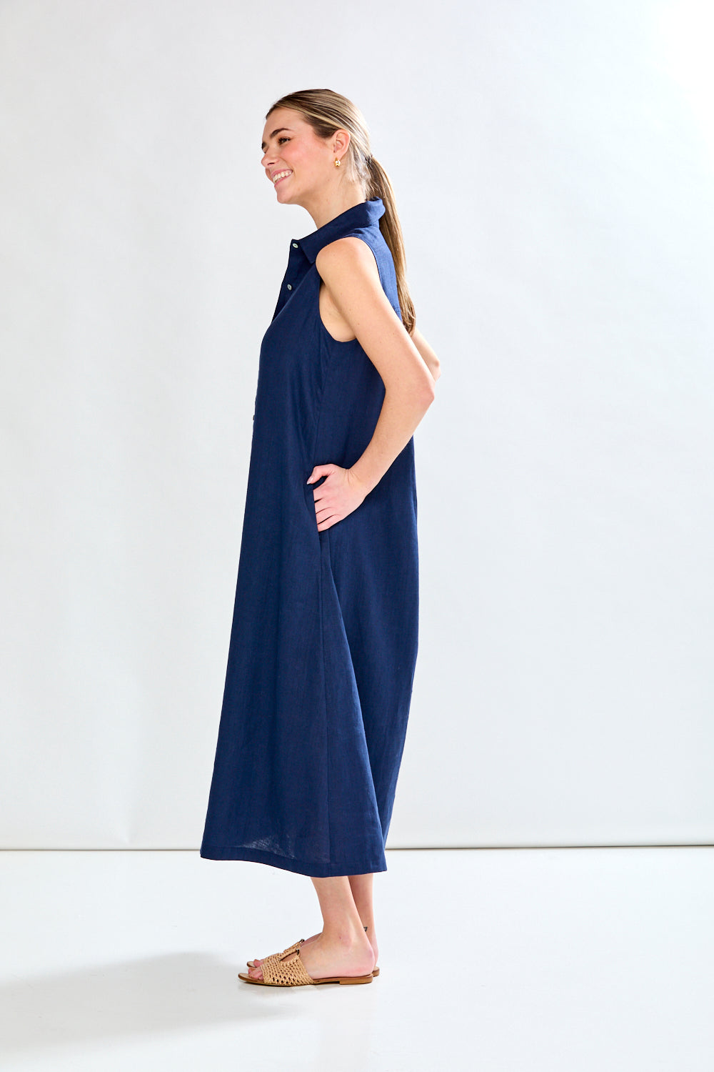 Woman in navy sleeveless dress