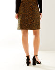 Woman in camel mini skirt with pockets