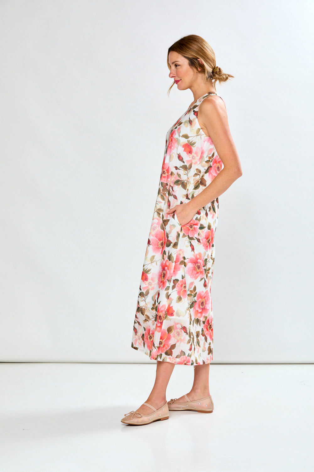 Woman in coral poppies dress