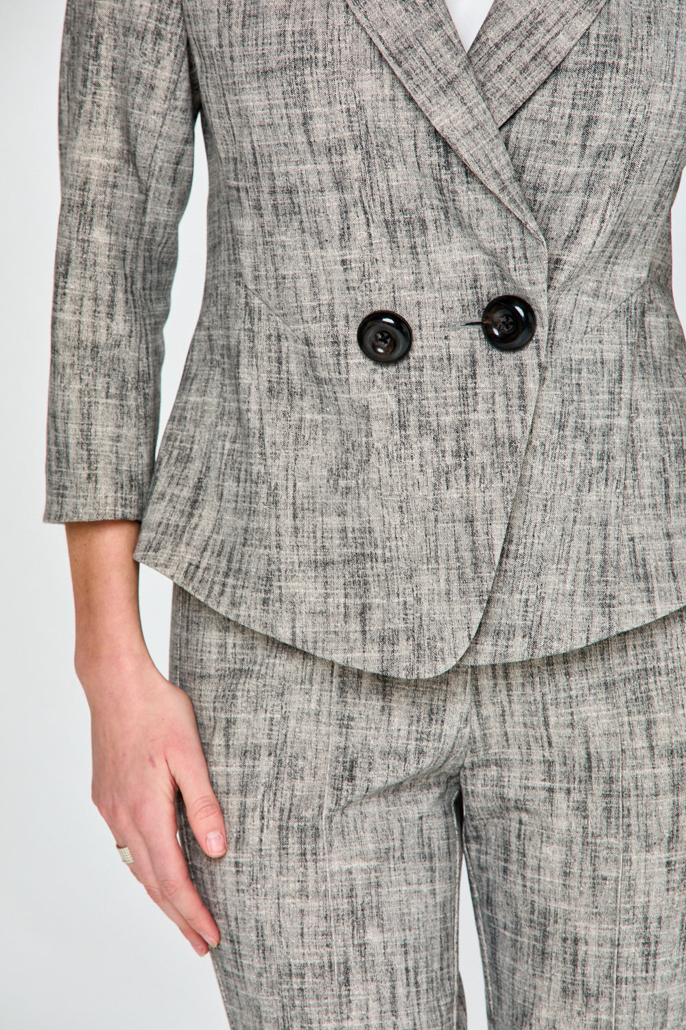 Woman wearing sand and black jacket