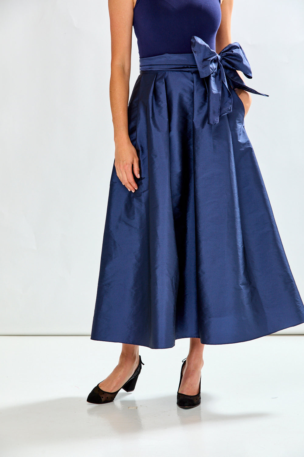 Woman wearing navy taffeta skirt