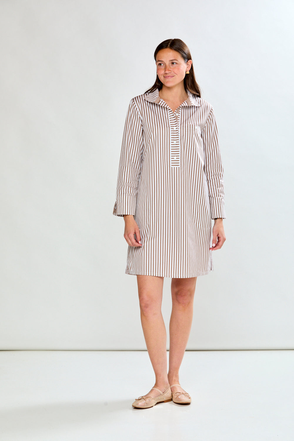 Woman wearing a striped dress against a white background