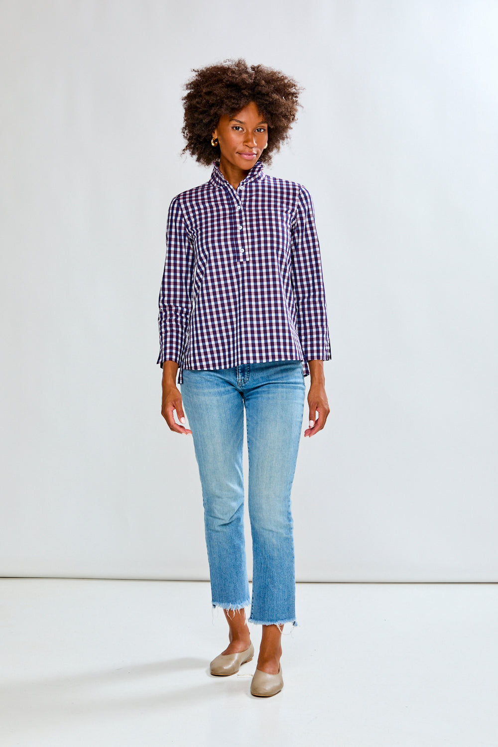 Woman in eggplant/white check top
