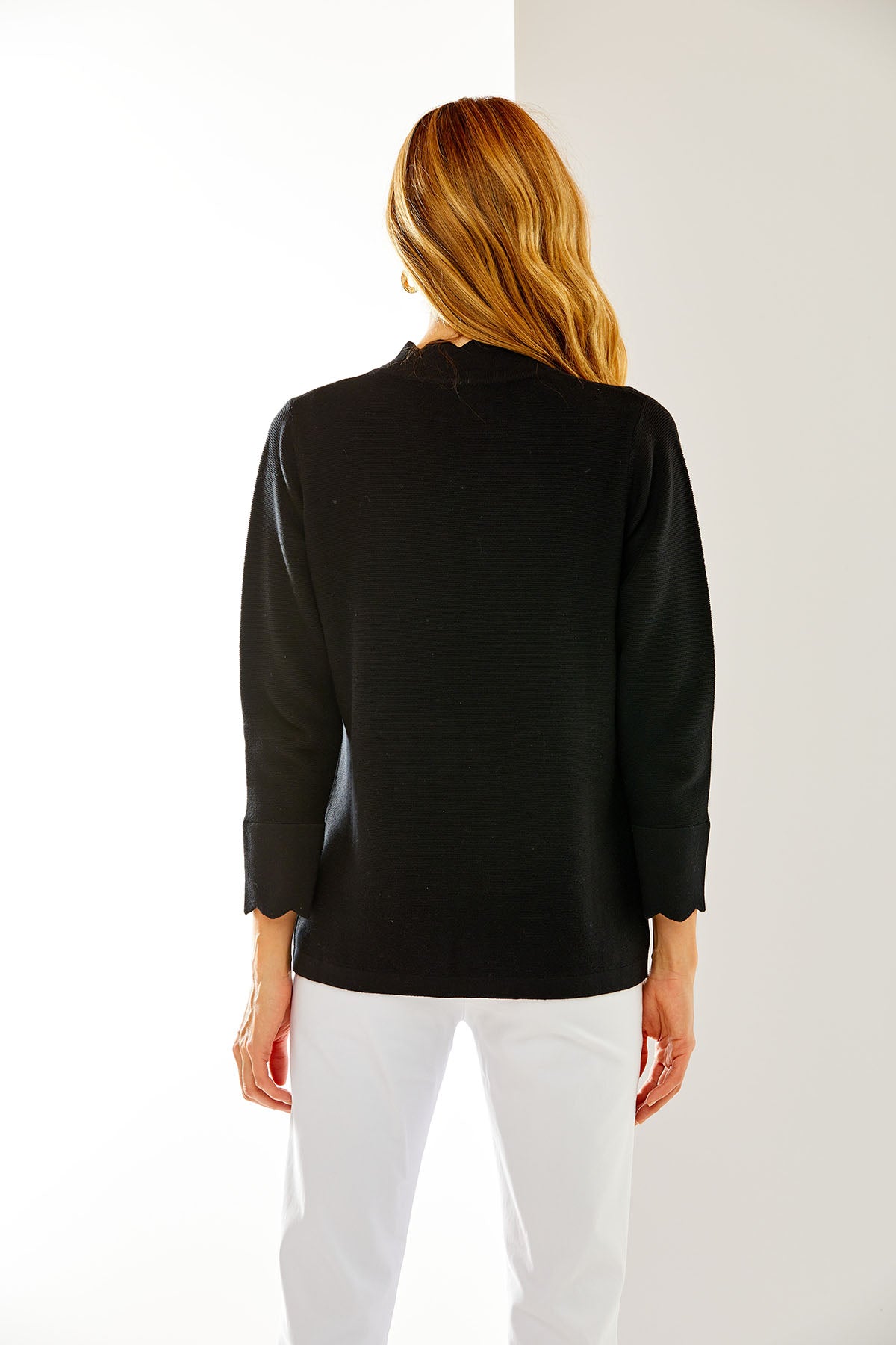 Woman in black scallop cardigan
