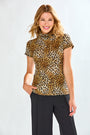 Woman wearing a leopard print top and black pants on a white background