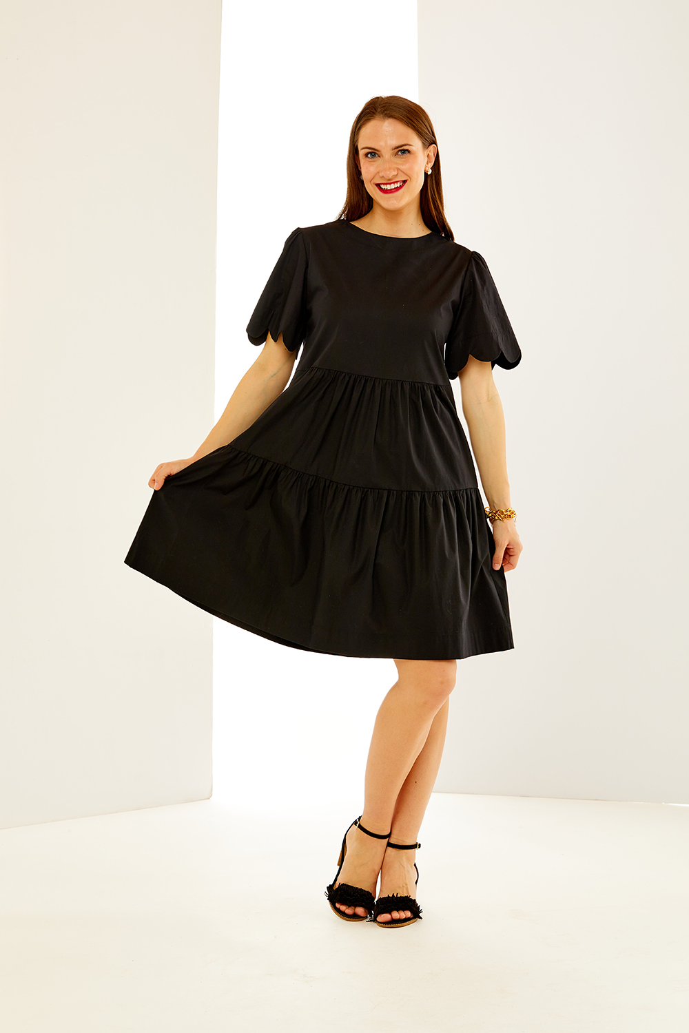 Woman in black scallop dress