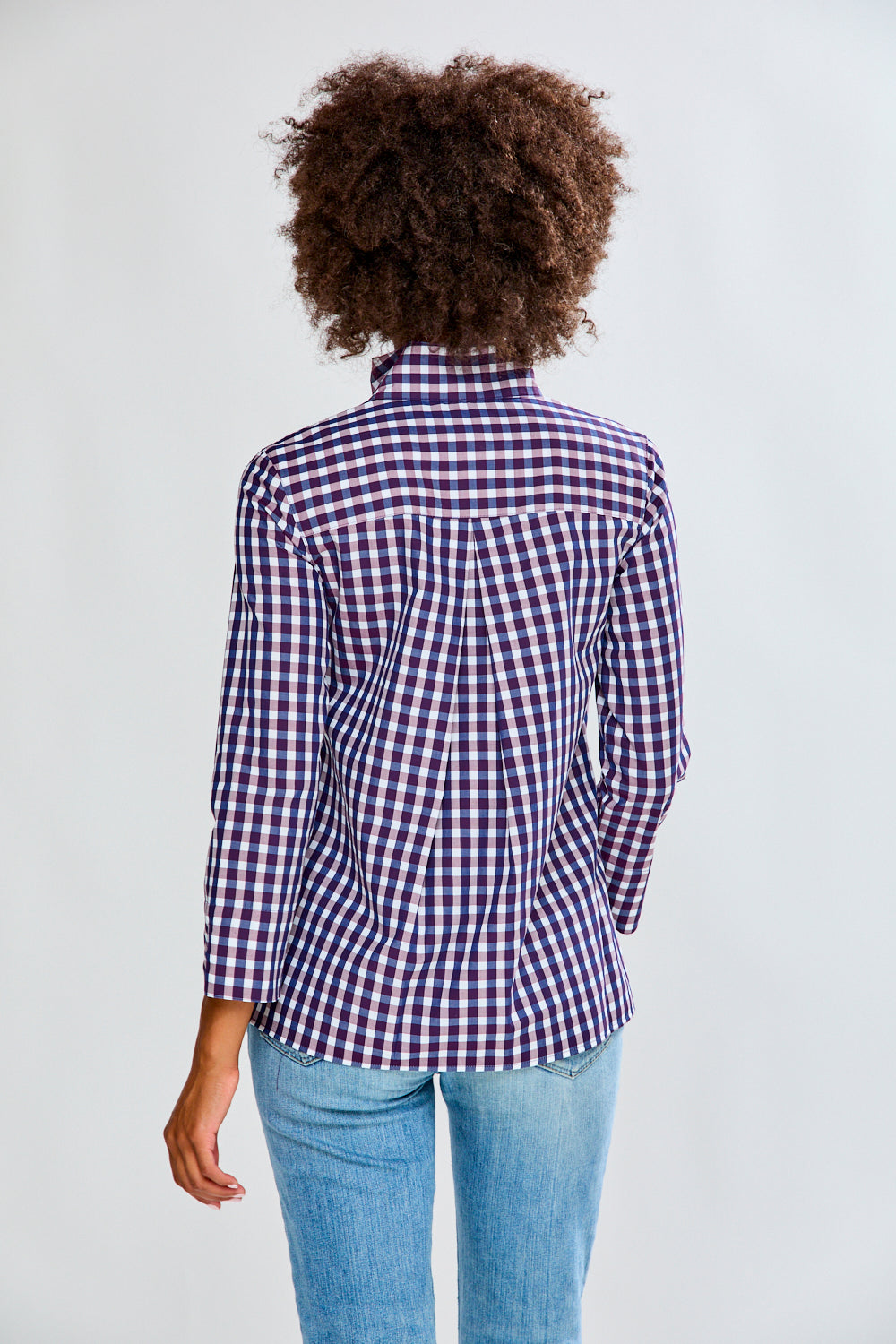 Woman in eggplant/white check top