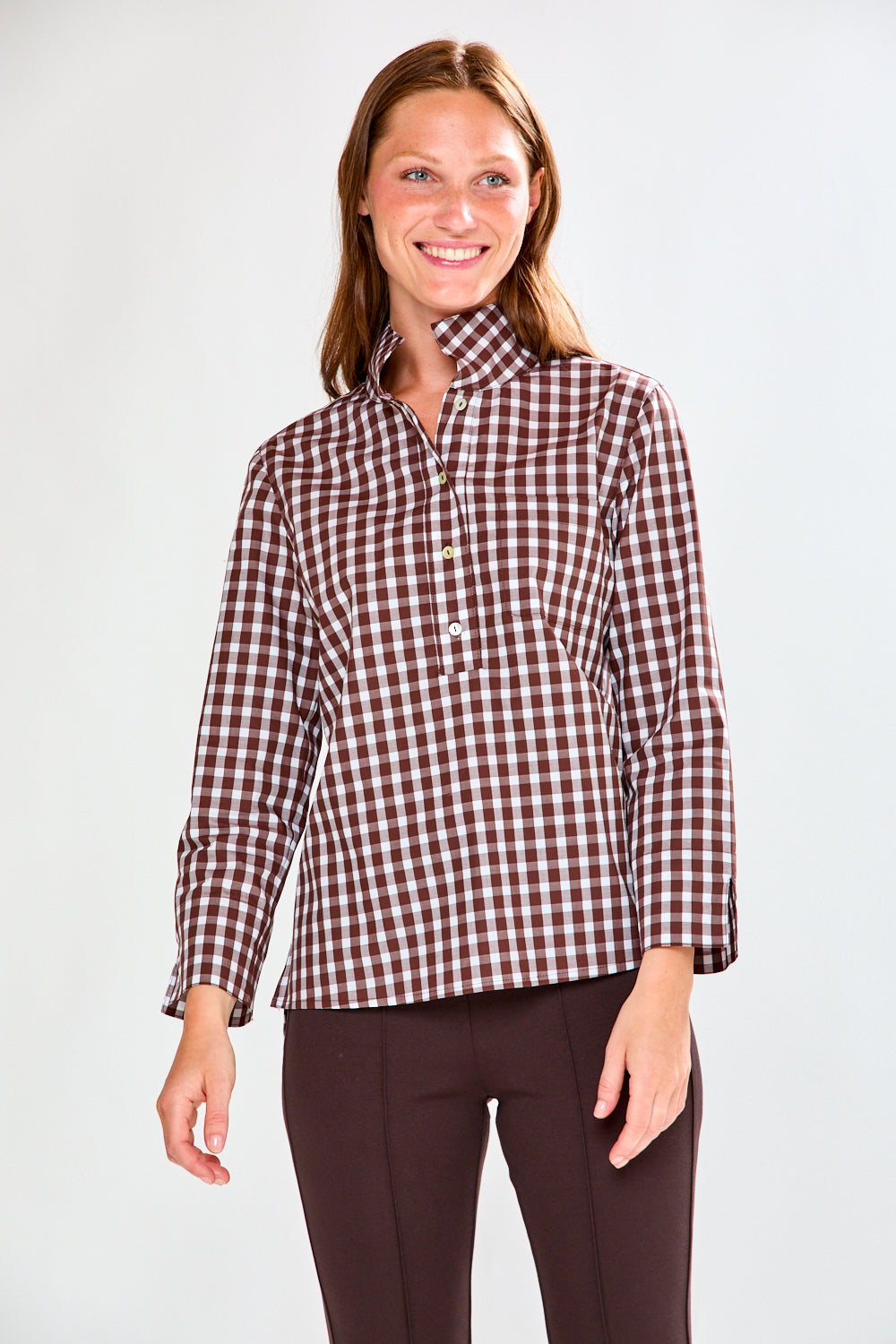 Woman in chocolate/white check top