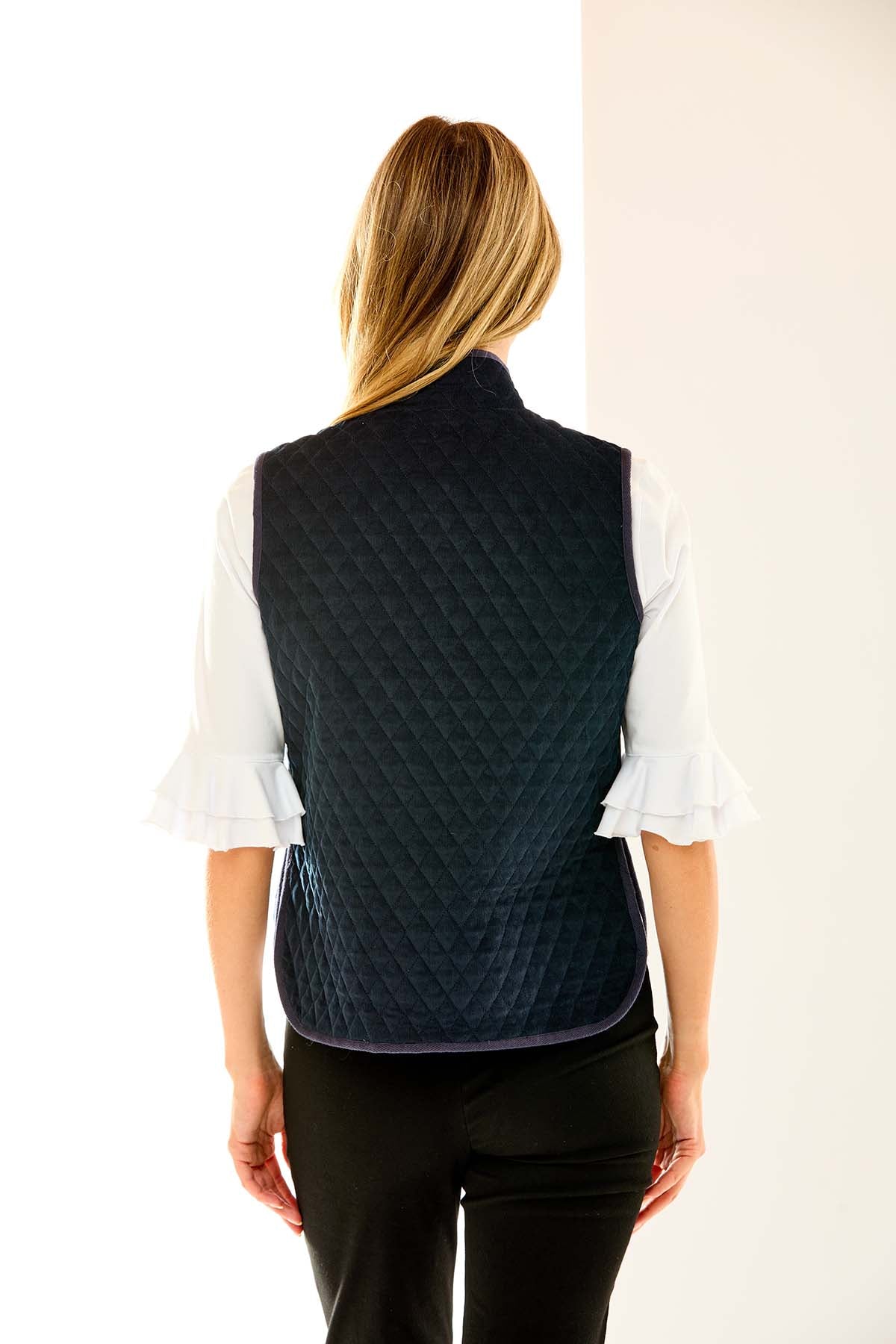 Woman in navy quilted vest
