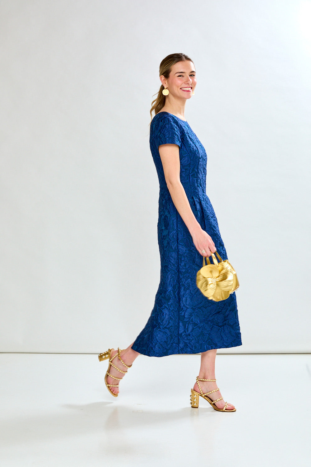 Woman in navy tea length dress