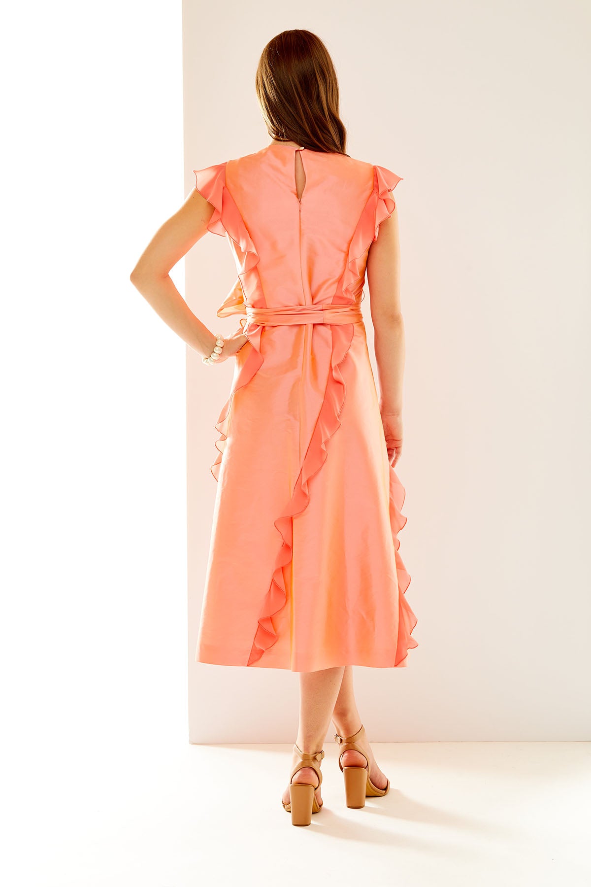 Woman in coral taffeta dress