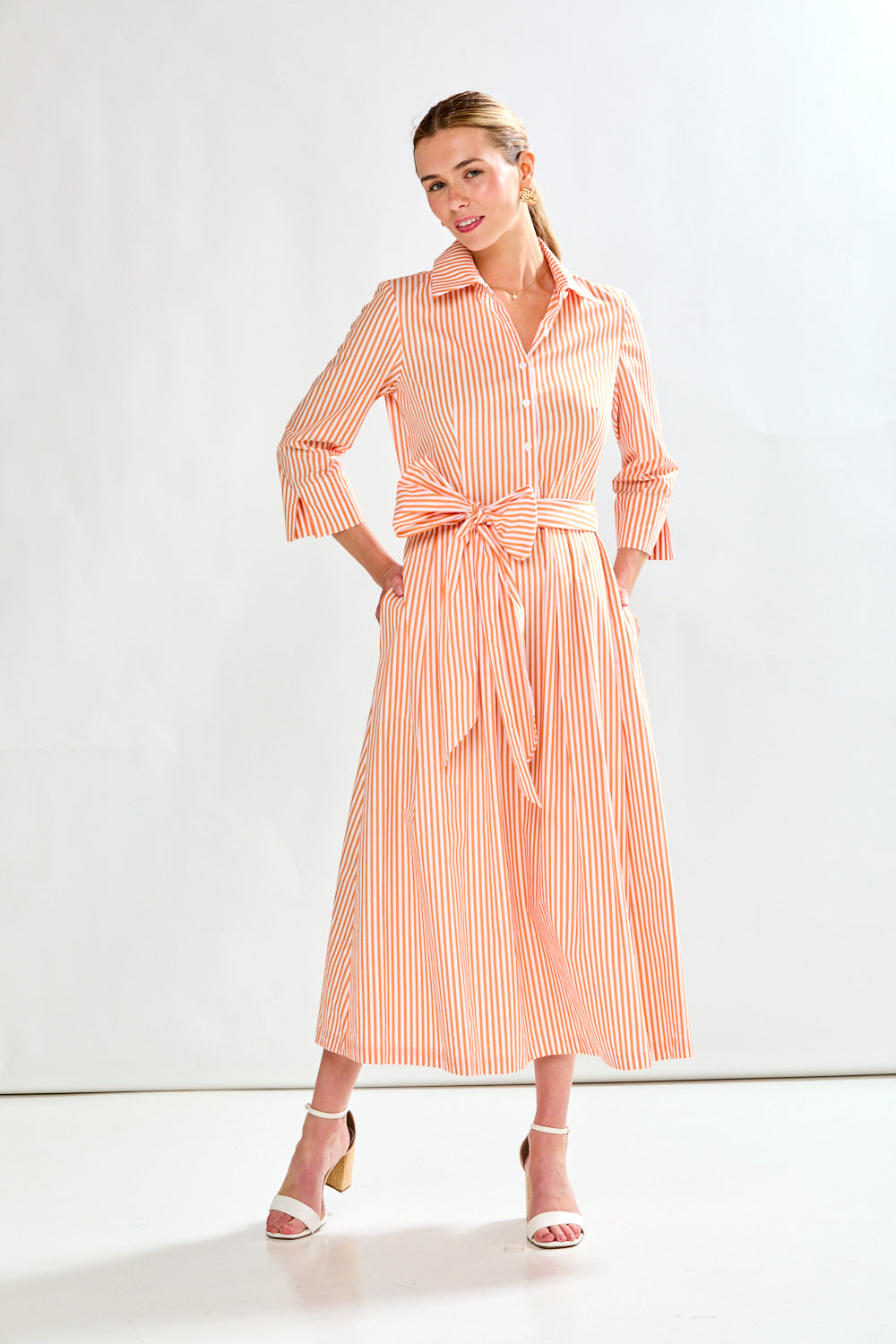 Woman in orange stripe dress