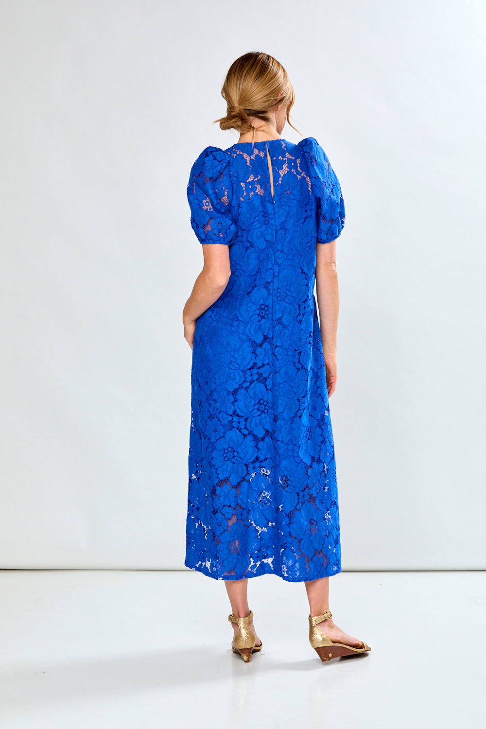 Woman in royal eyelet dress