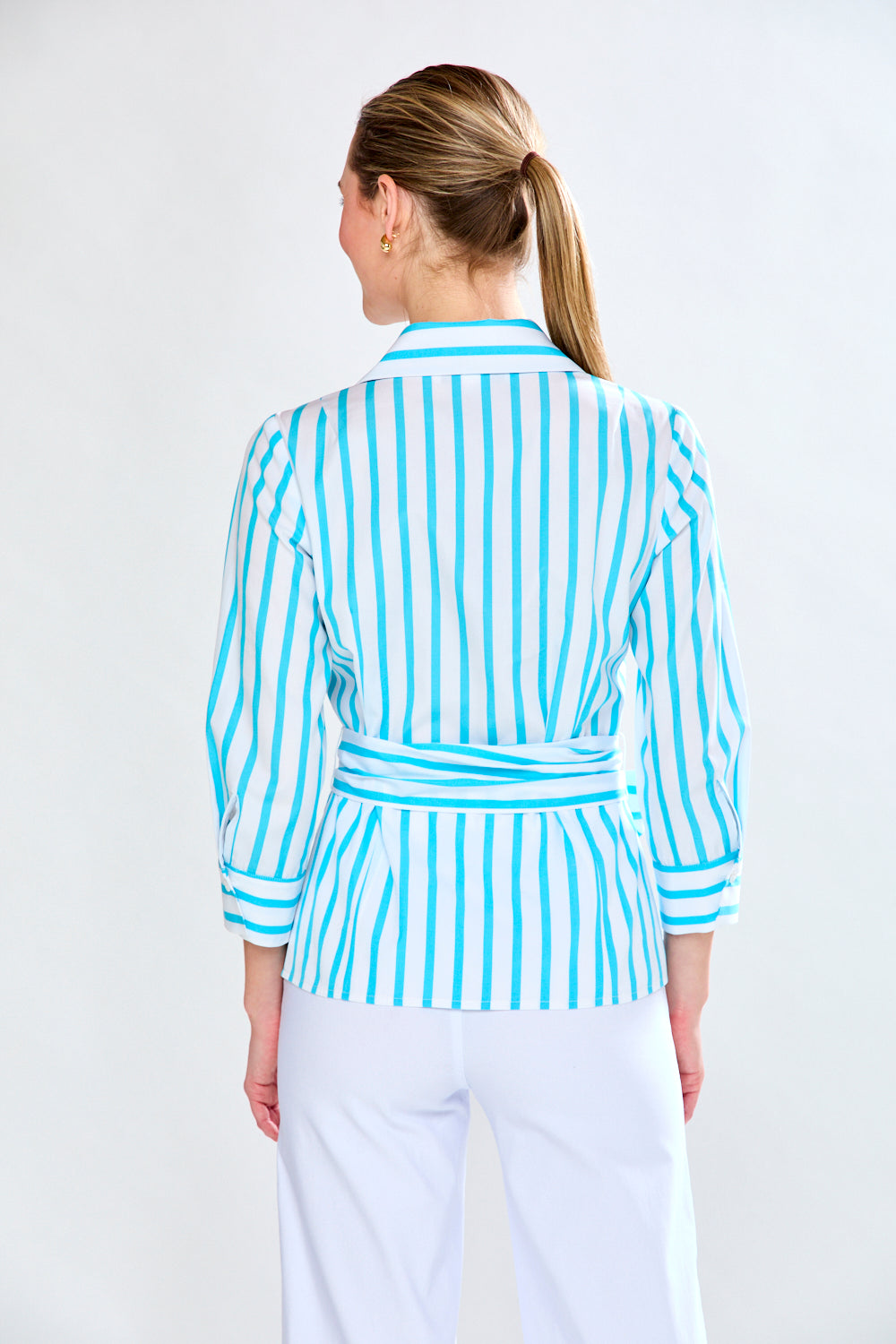 Woman in aqua and white stripe top