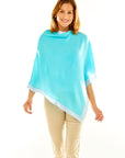 Woman in aqua poncho