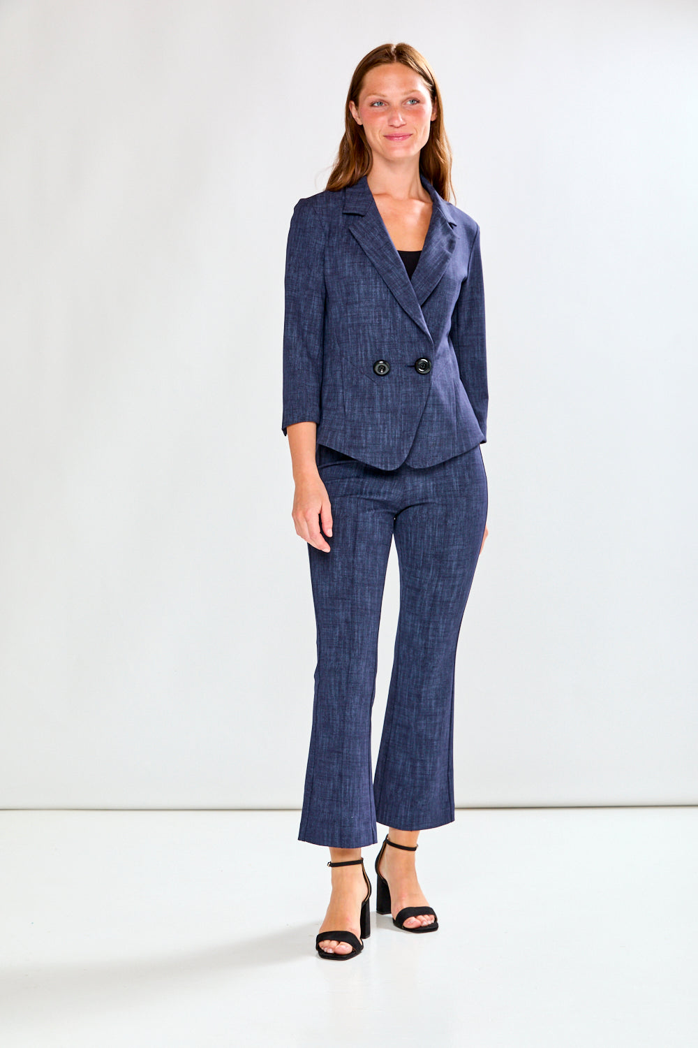 Woman wearing a blue suit with a white background