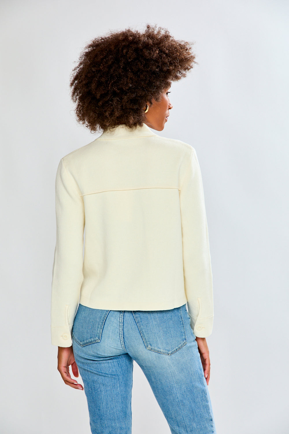 Woman in ivory sweater jacket