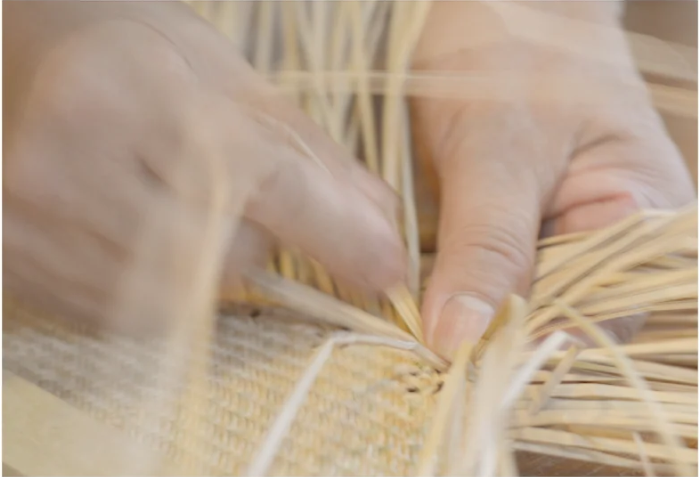 A photo of a hands weaving
