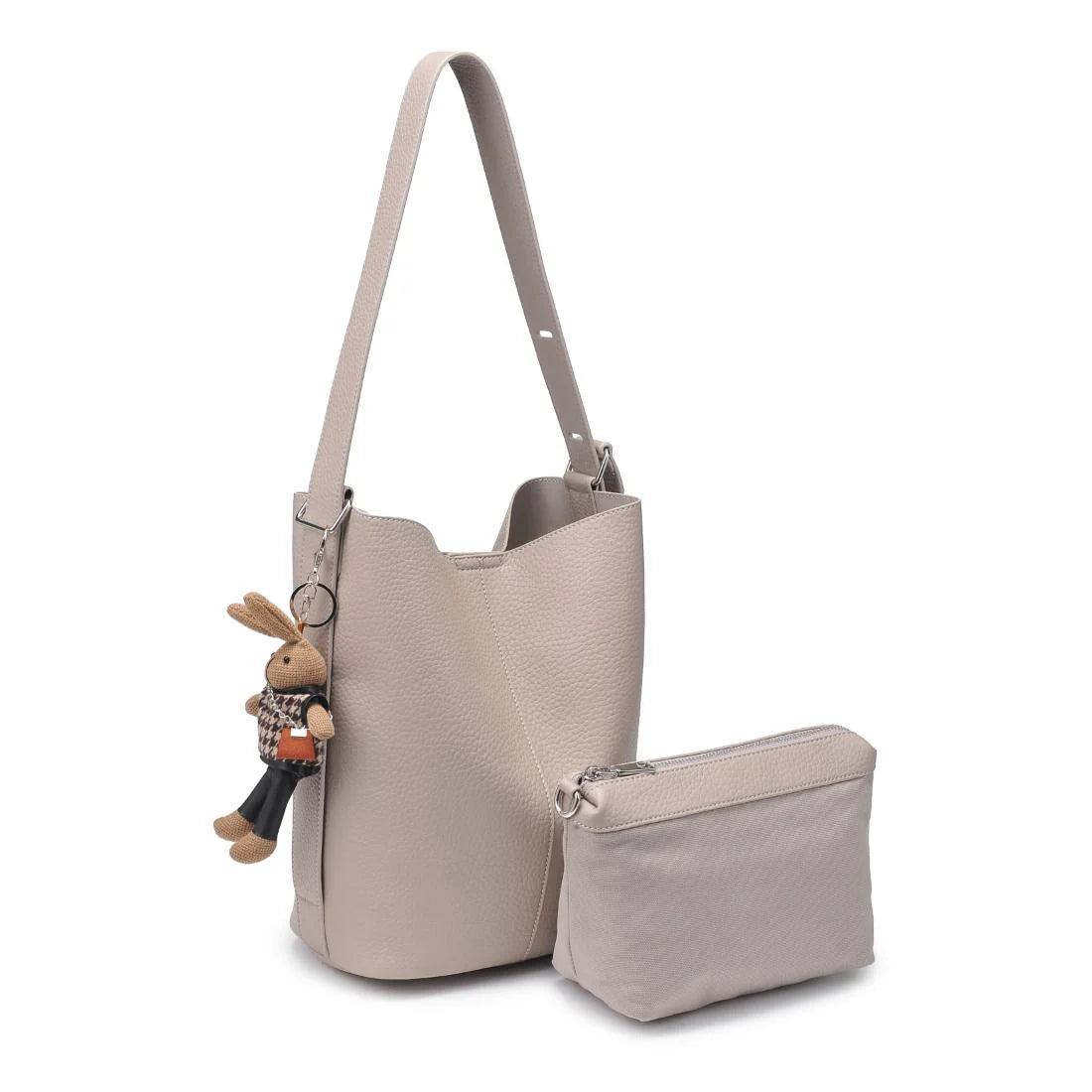 Beige handbag with matching pouch and rabbit charm on a white background