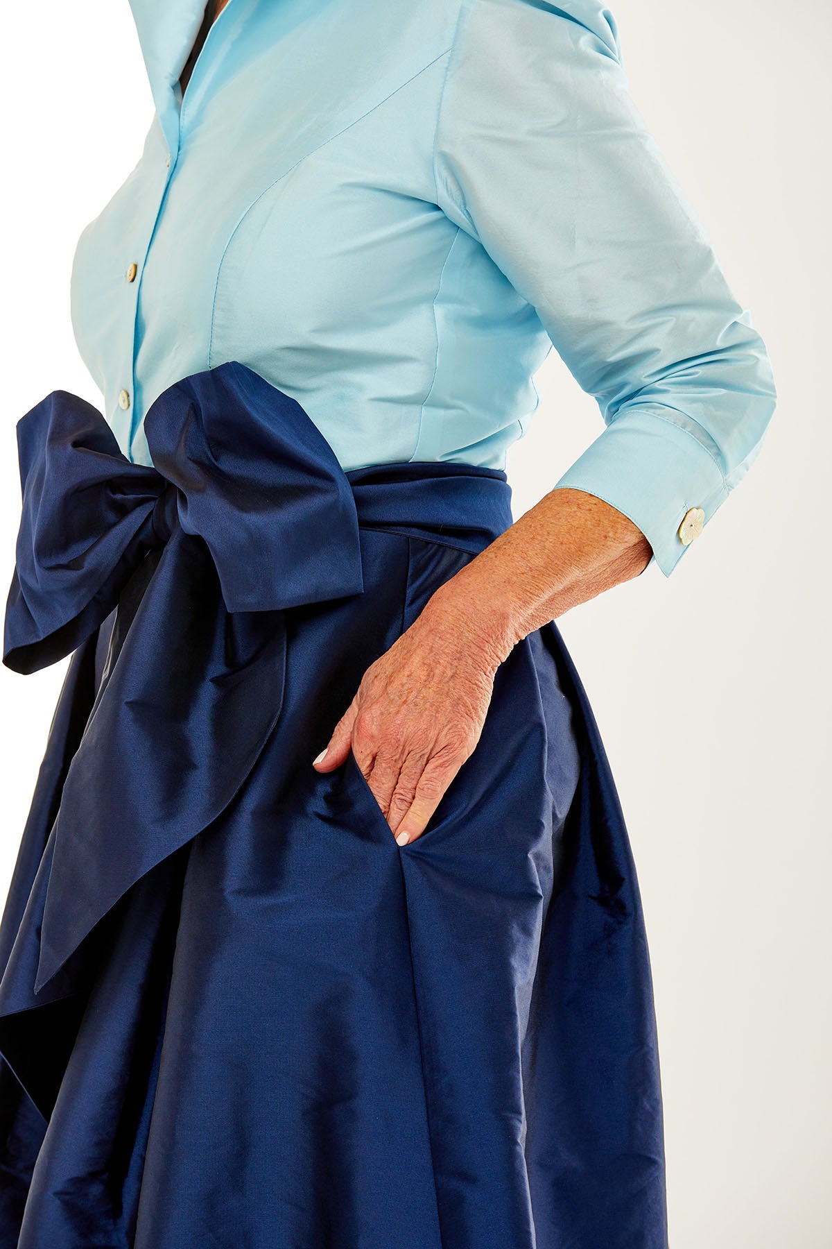Woman in light blue/navy dress