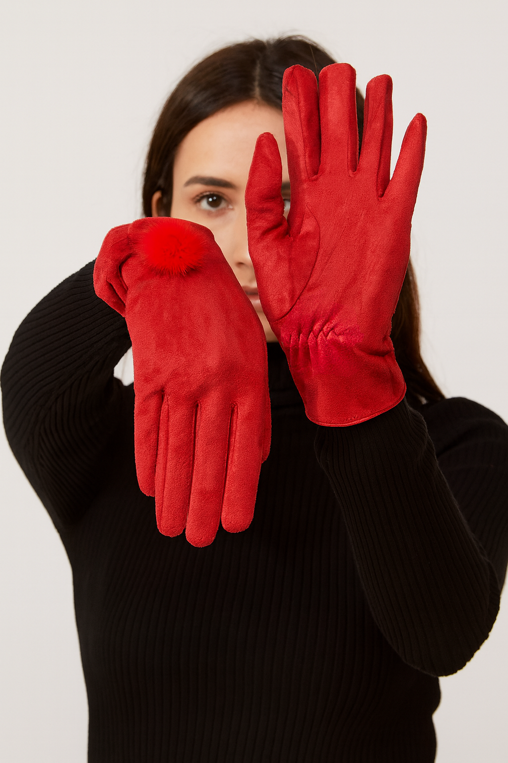 Woman wearing red faux sueded faux fur gloves.