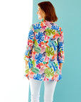woman in multi-color palm print button down tunic