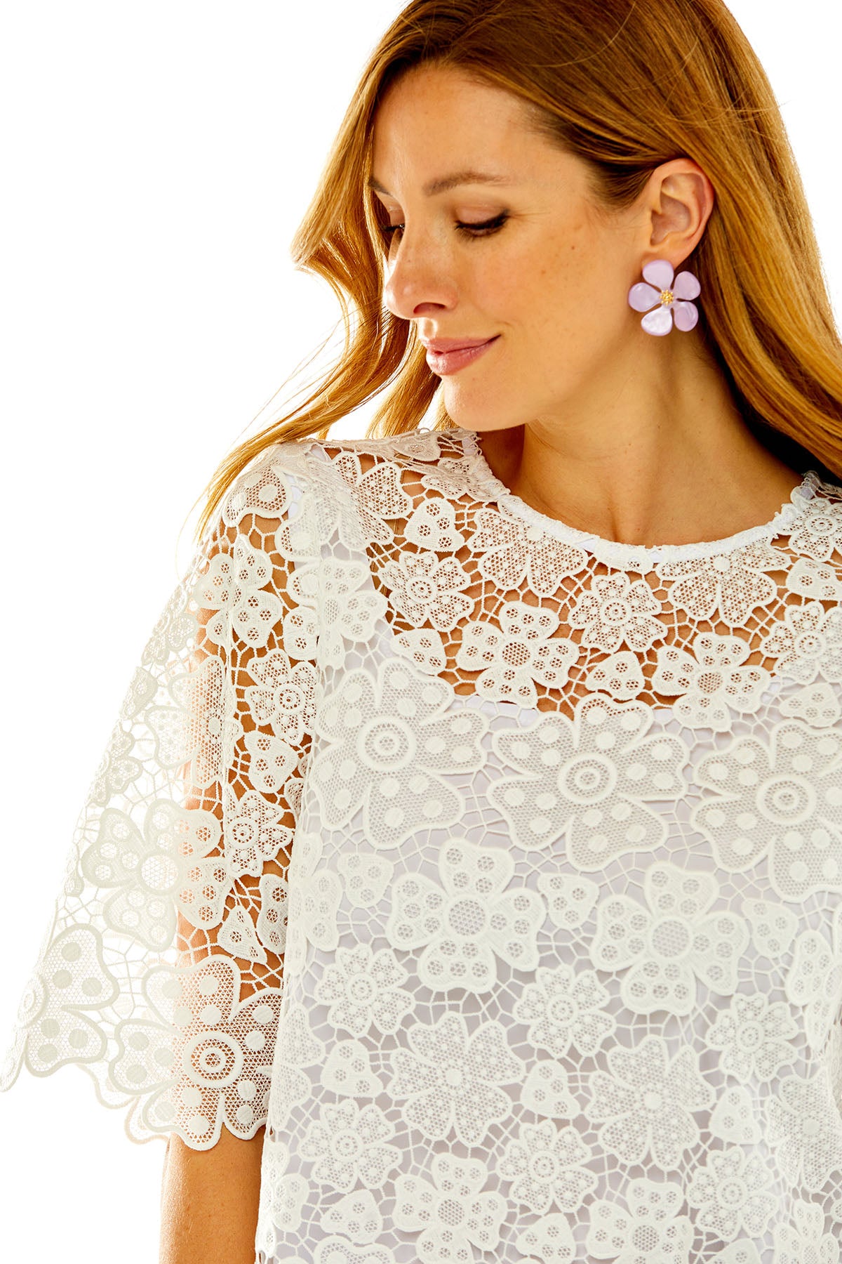 Woman wearing light pink flower earrings