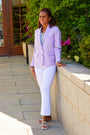 Woman in white pants and a purple jacket