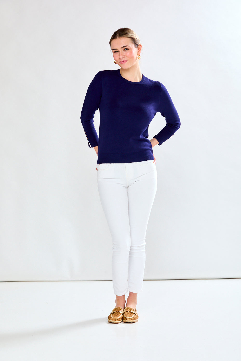 Woman in navy/white sweater