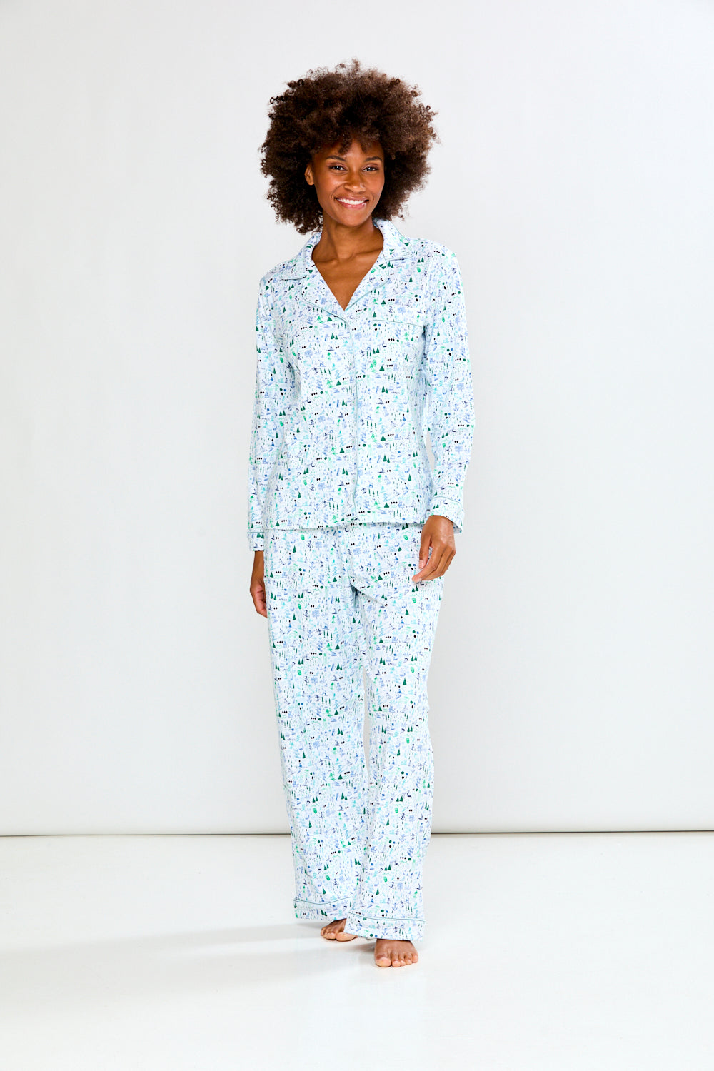 Woman wearing a light blue pajama set on a white background