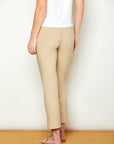 Woman in fitted sand colored pants