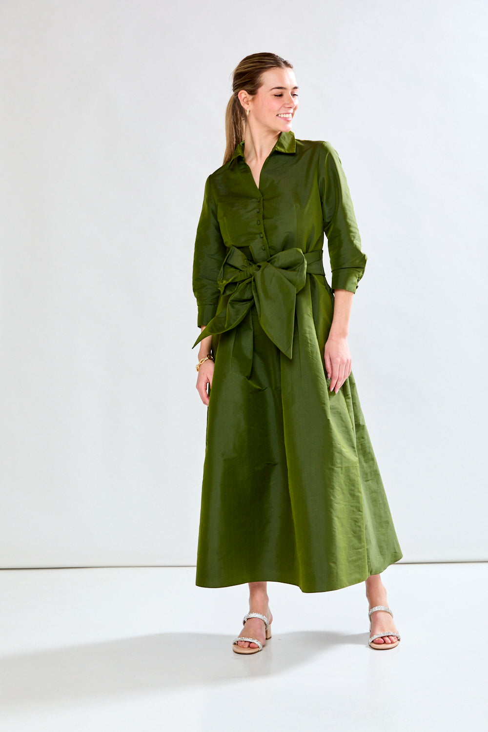 Woman in olive taffeta dress