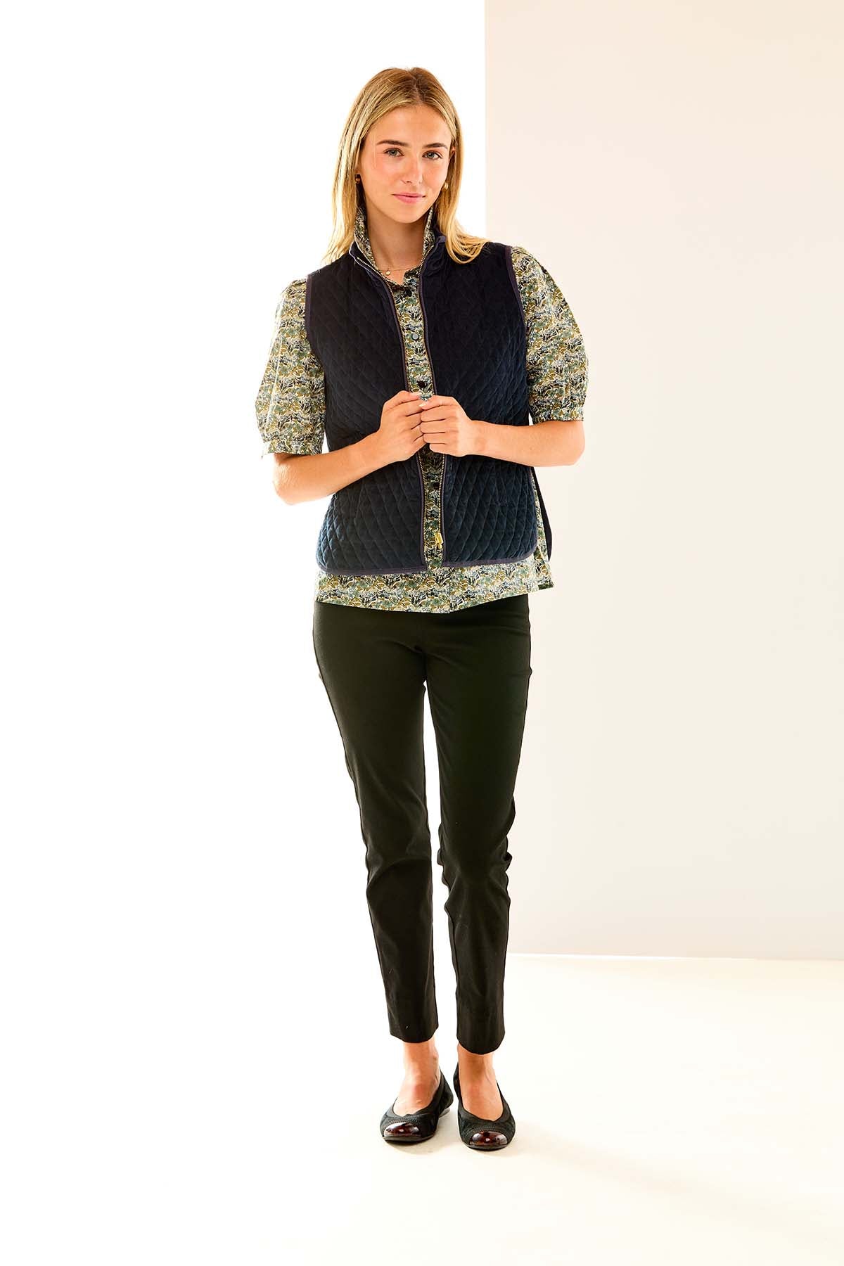 Woman in navy quilted vest